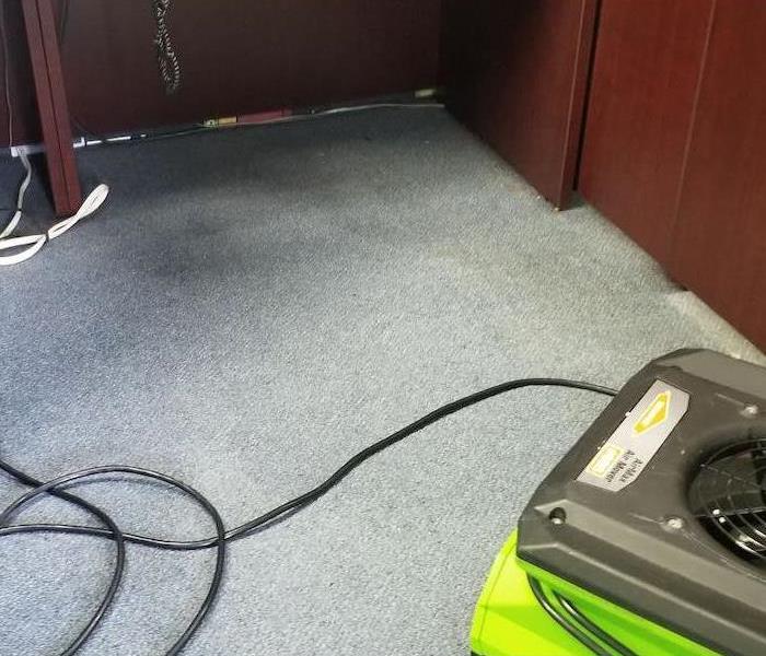 Desk with SERVPRO drying equipment