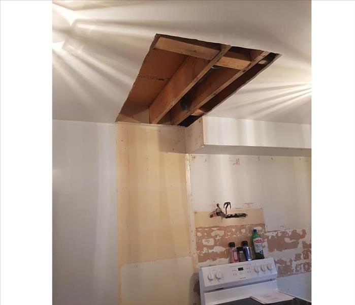the same view with a rectangular cutout and removal of damaged ceiling material, no tape