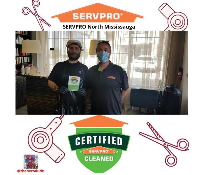SERVPRO tech giving cleaning certificate to hair salon worker
