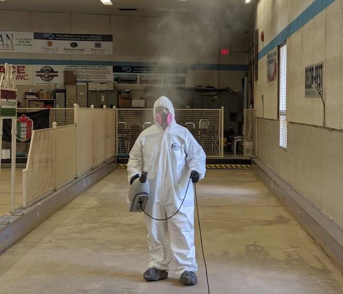 SERVPRO tech in PPE with steamer in club
